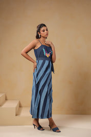 Side profile of Turtletide Flare Dress featuring fitted bodice, waist tie-up belt, and flowing layered denim panels