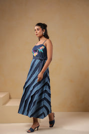Model walking in Turtletide Flare Dress showcasing fluid spiral flare movement and embroidered details