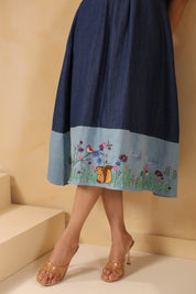 Floral meadow embroidery with chipmunk motif at the hem of the Woodland Muse Midi Dress