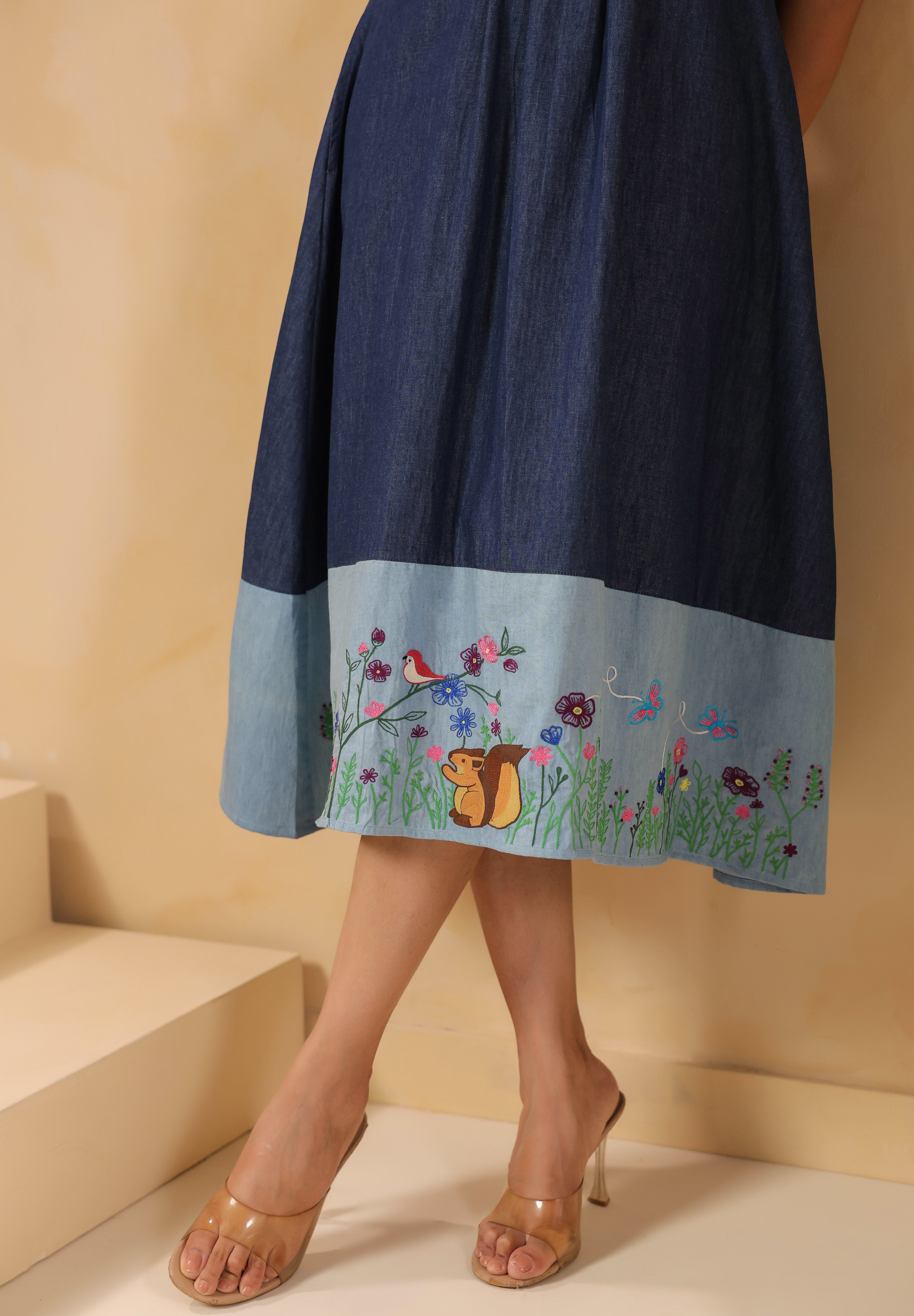 Floral meadow embroidery with chipmunk motif at the hem of the Woodland Muse Midi Dress